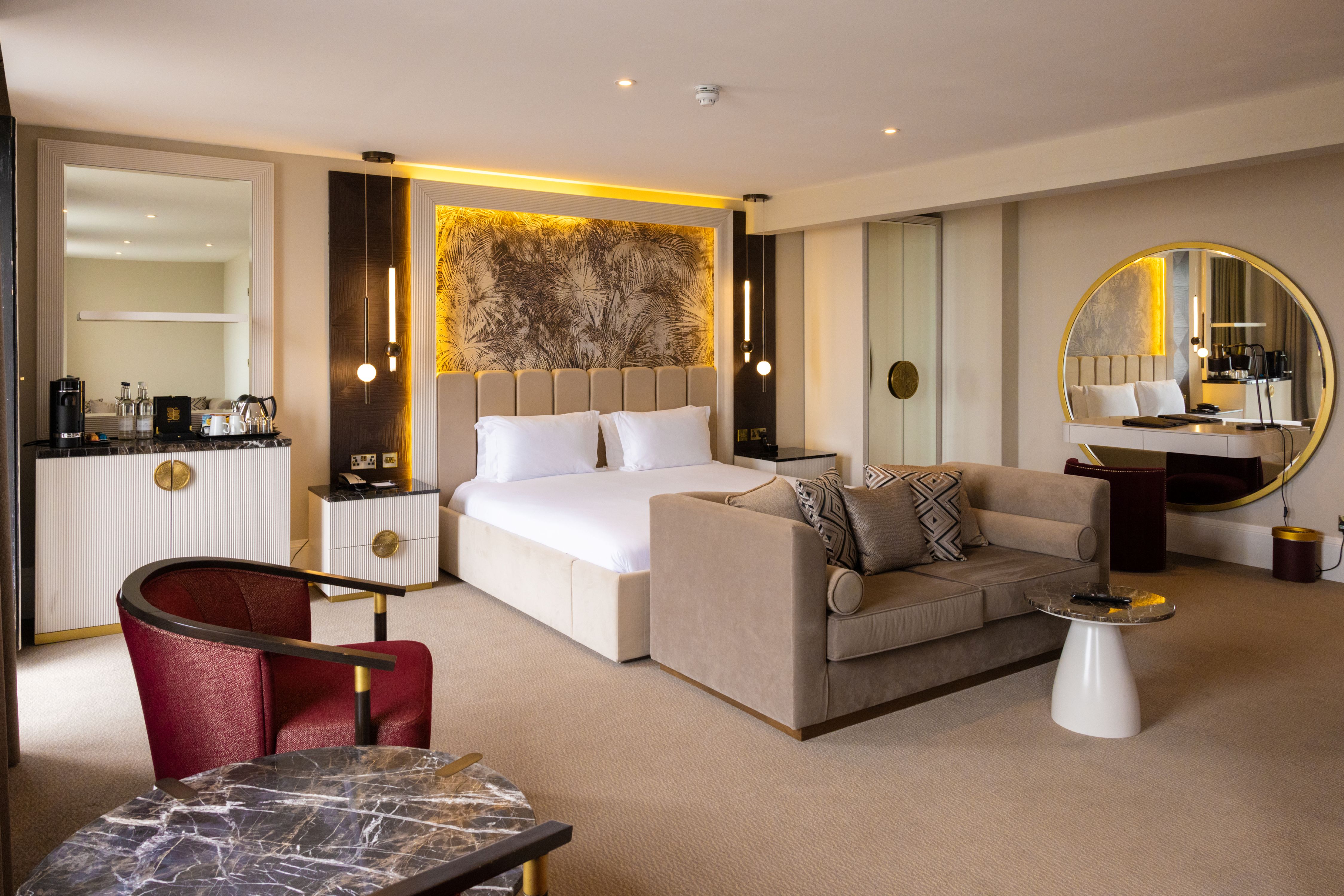 An elegant suite at the Dover Marina Hotel &amp; Spa featuring a king bed and couch