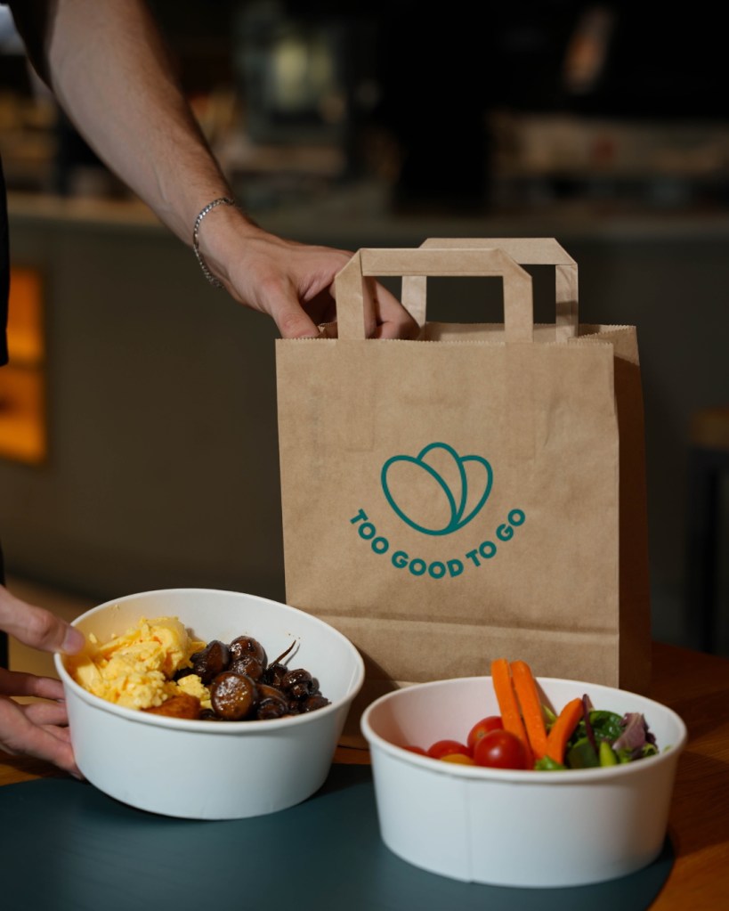 Two bowls of food in front of a Too Good To Go bag