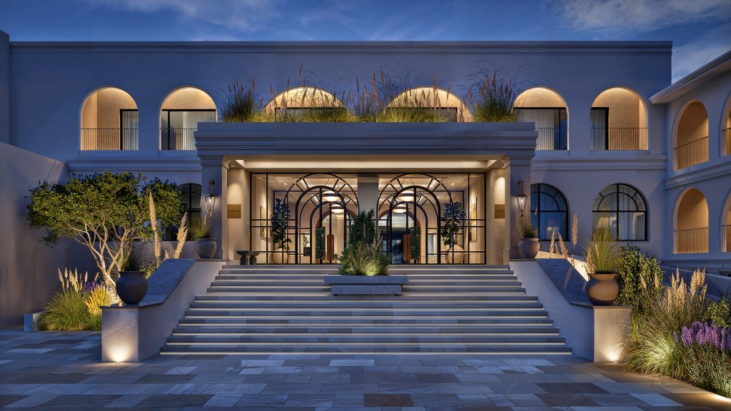 Conrad Corfu - Entrance at Night - wide staircase leading up to large glass doors and curved details