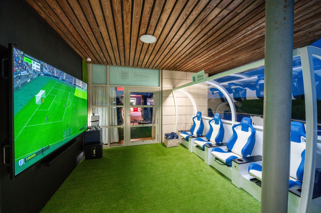 A space to watch the game, featuring large tv, and theatre style seats.