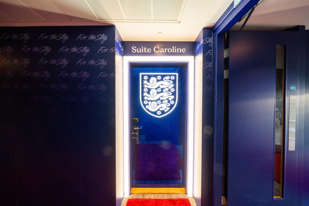 The door to the suite covered in blue with the logo of the England national football team