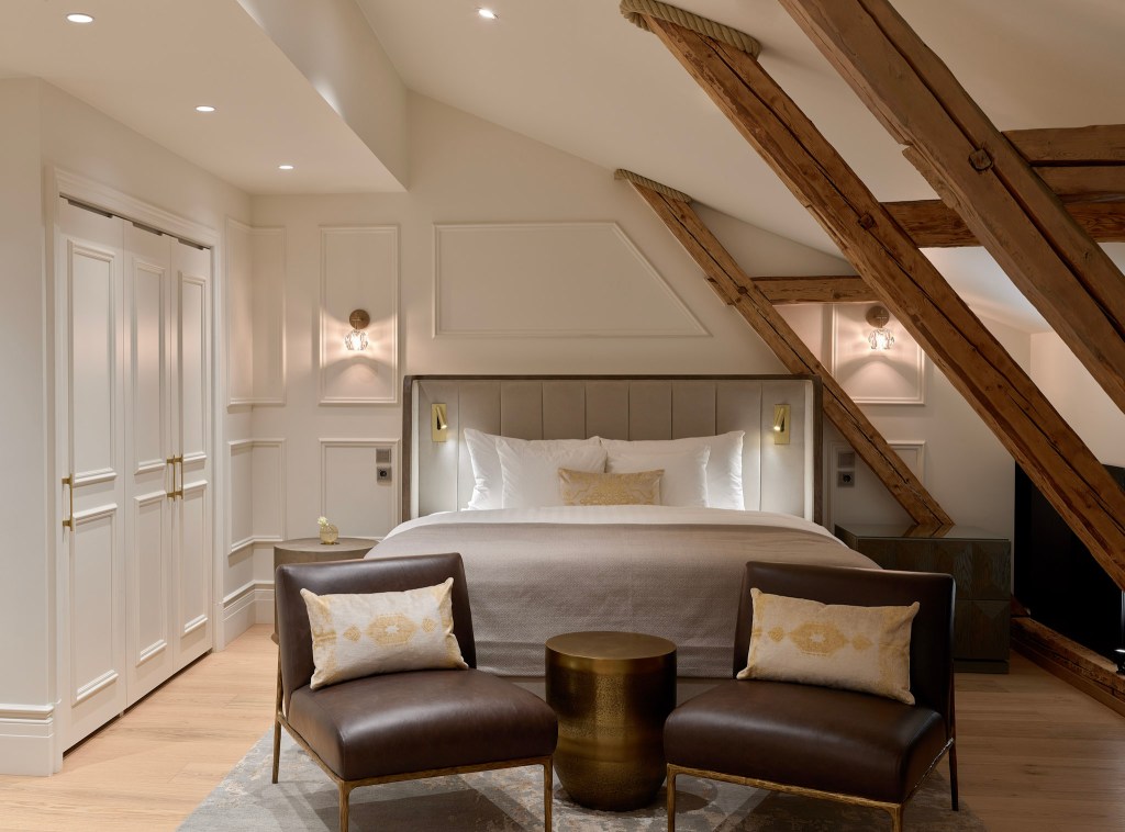Cozy suite with exposed beams and seating area.