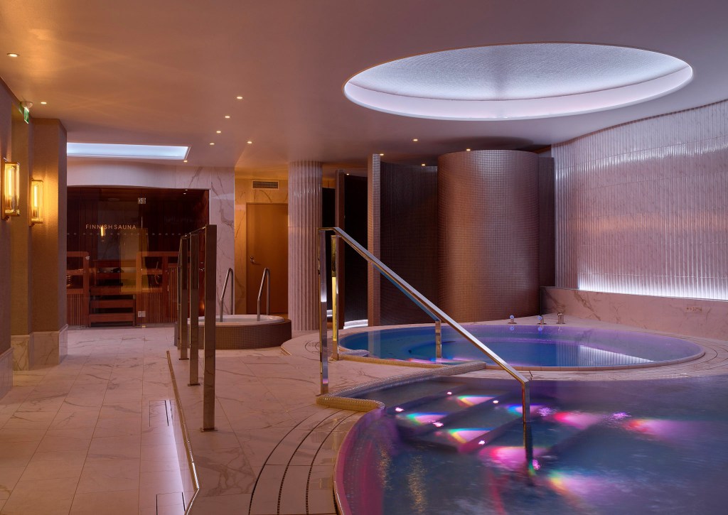 Luxurious spa with pools, sauna, and soft lighting.