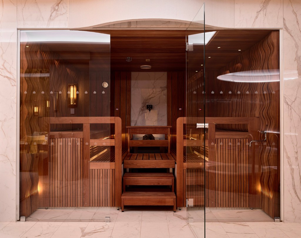 Luxurious wooden sauna with glass doors.