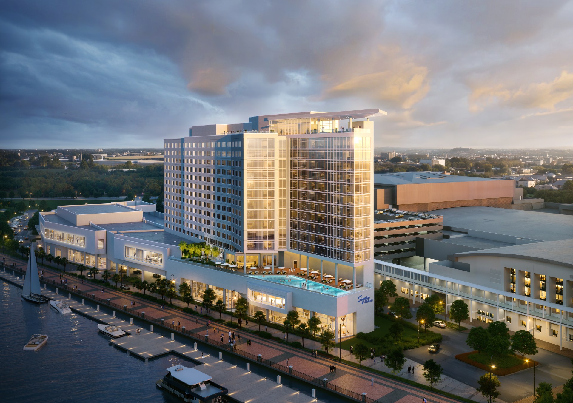 The exterior of the hotel with the water and boardwalk running in front