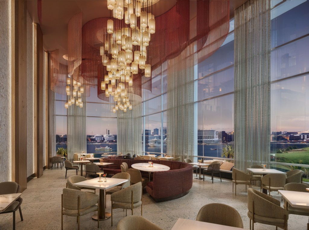 A dinging room with various seating options and large windows looking out at the Savannah River