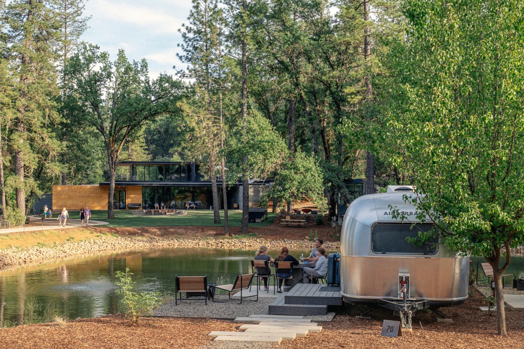AutoCamp Yosemite - California - group of people sitting outside of Airstream on a sunny day