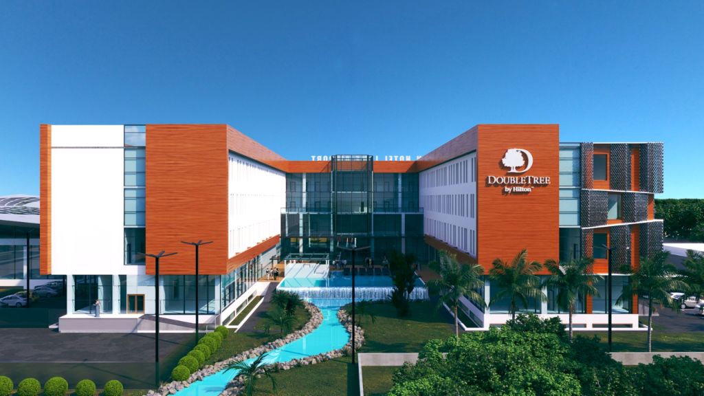 An exterior shot of the hotel, featuring the pool in the middle