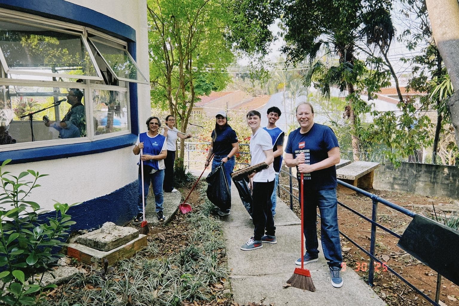 Hilton Travel with Purpose Week 2025 - Hilton Sao Paulo Morumbi - team members with brooms and trash bags outside
