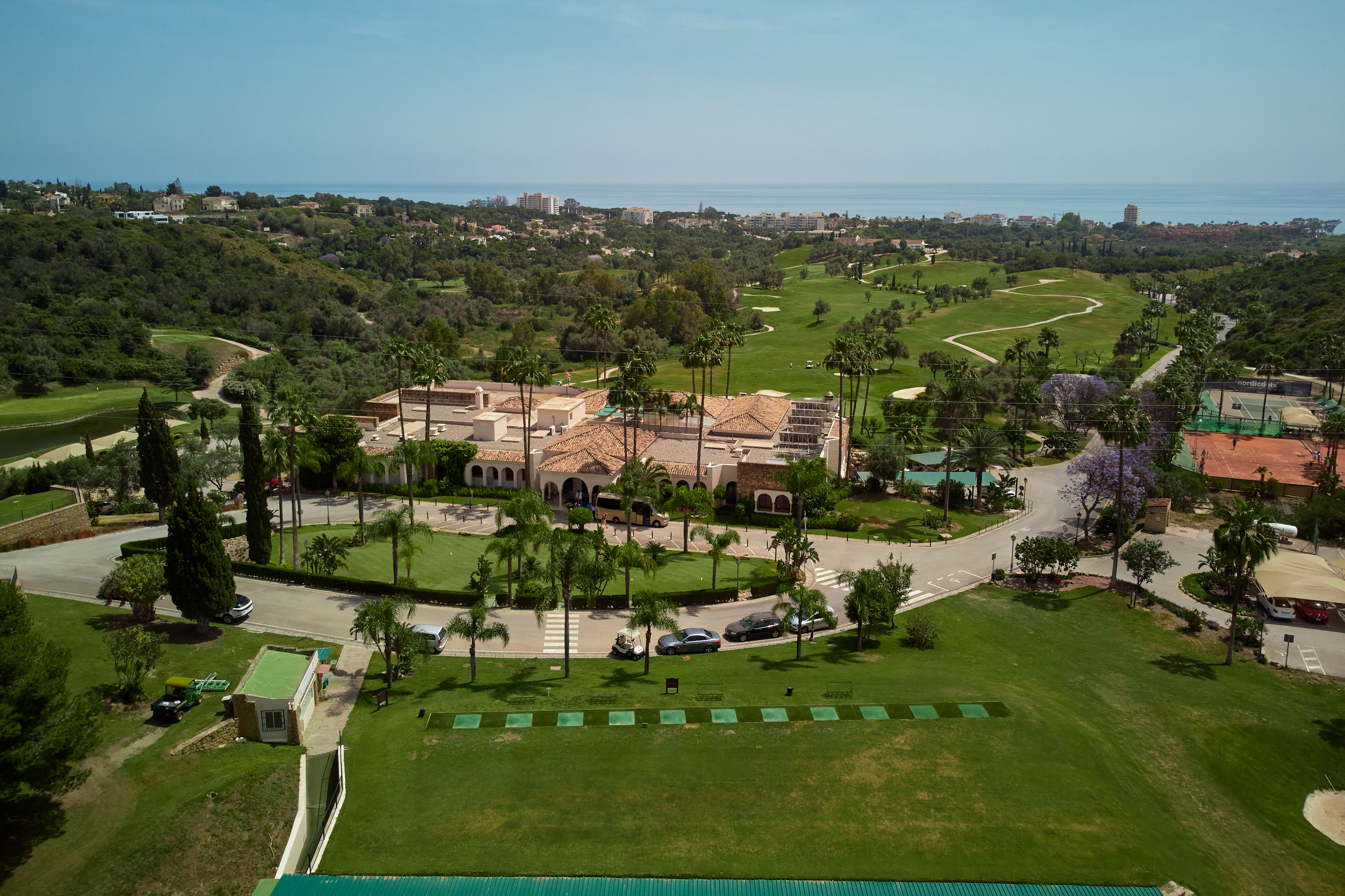 An aerial shot of the hotel with a golf course in the background
