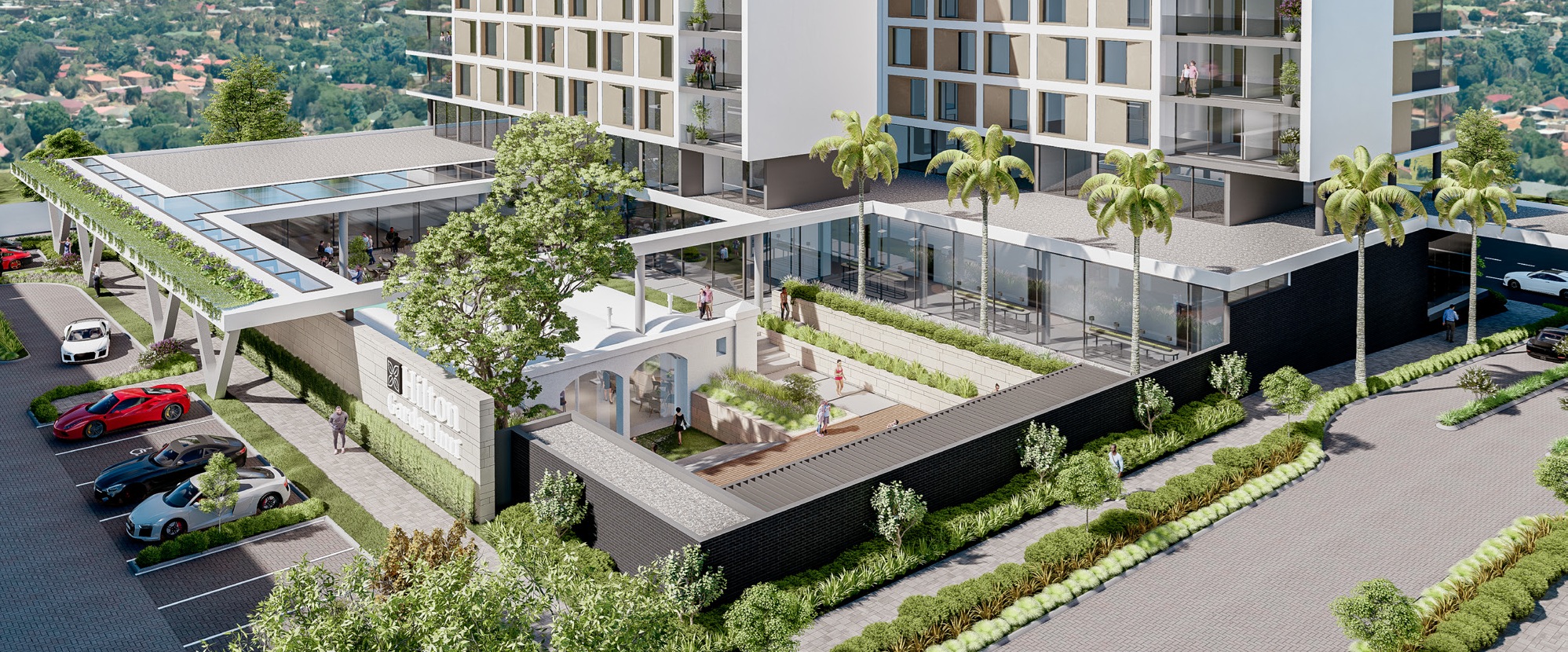 Modern Hilton Garden Inn with balconies, glass windows, landscaped courtyard, palm trees, and parking area with multiple cars.