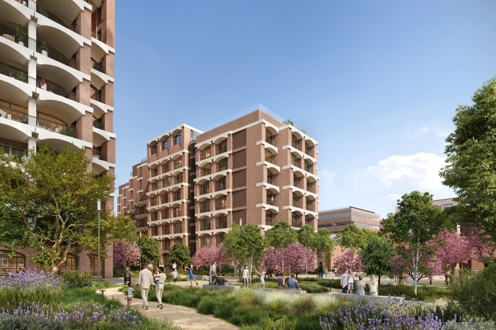 Urban park with people walking and sitting, surrounded by modern brick buildings of the Hilton Thessaloniki and blooming trees under a clear blue sky.
