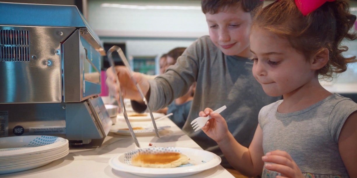 Kids using the Tru by Hilton Pancake Maker