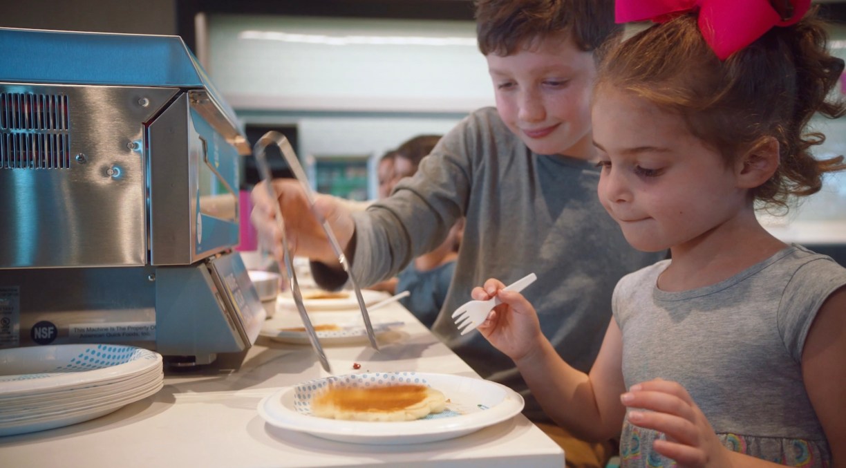 Kids using the Tru by Hilton Pancake Maker