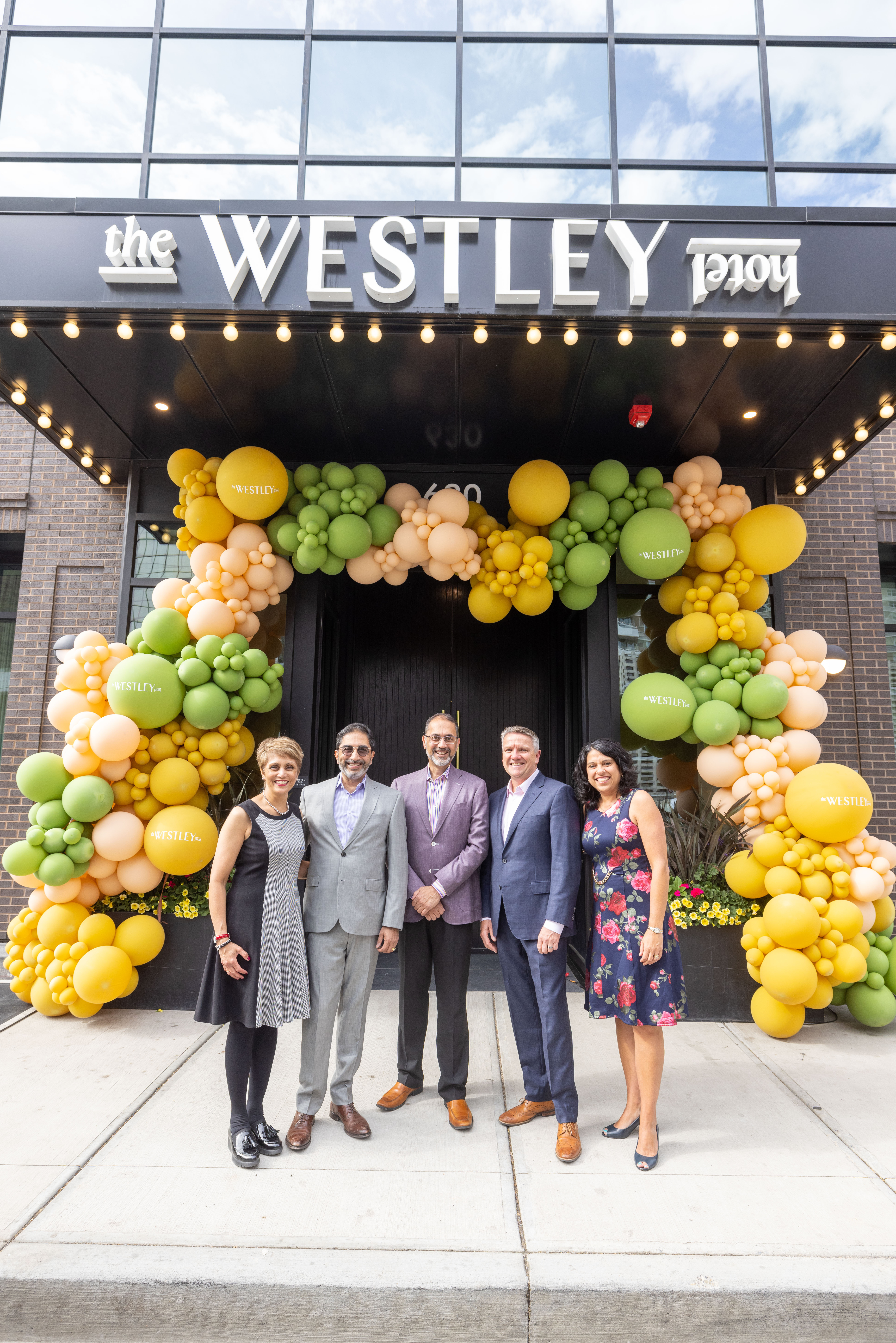 mayor and hotel leaders in front of The Westley Hotel