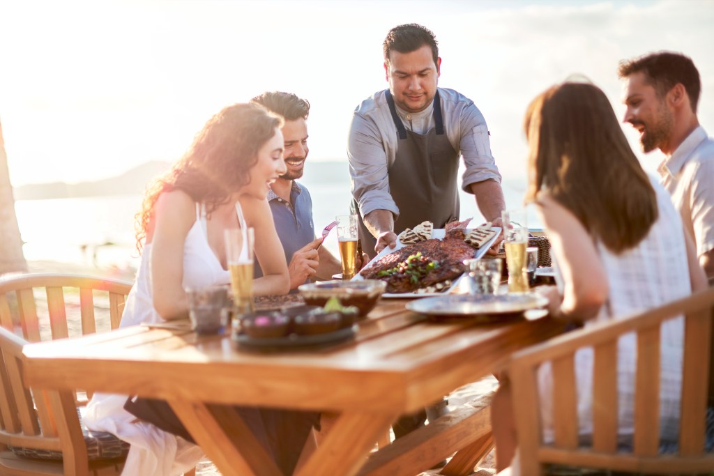 chef bringing food to table Conrad Punta de Mita Zarandeado beach experience