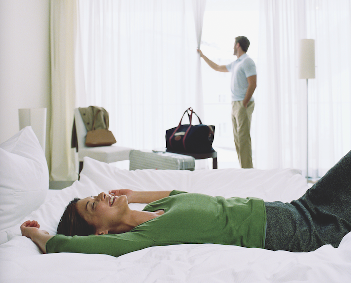 woman hotel bed hilton honors