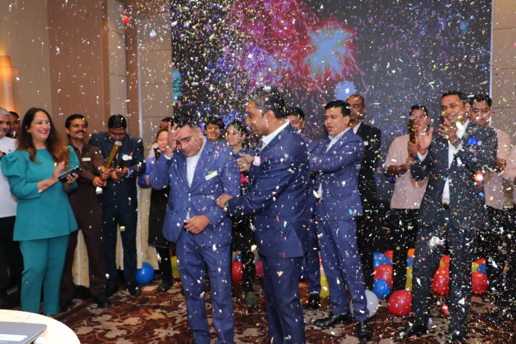 celebration with confetti and team members for 2022 CEO Light &amp; Warmth Award Winner Upendra Singh