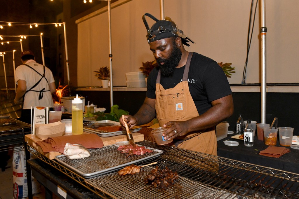 Omar Tate prepares his culinary creation at an exclusive Hilton Honors event with Questlove at Motto by Hilton New York City Chelsea