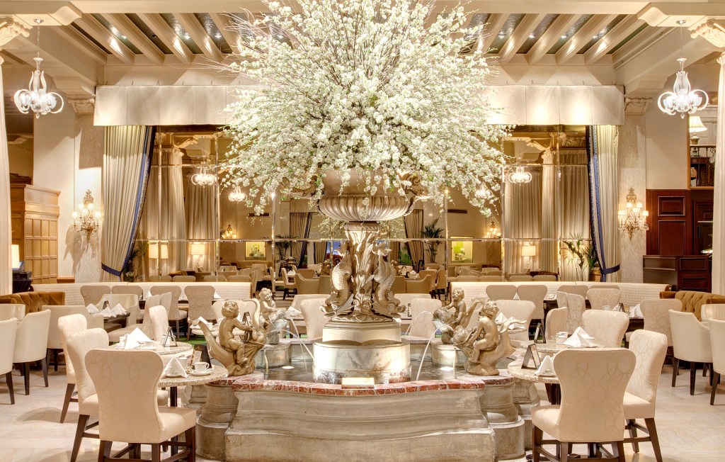 fountain, flower display, dining seating at Palm Court at The Drake Hotel, Chicago