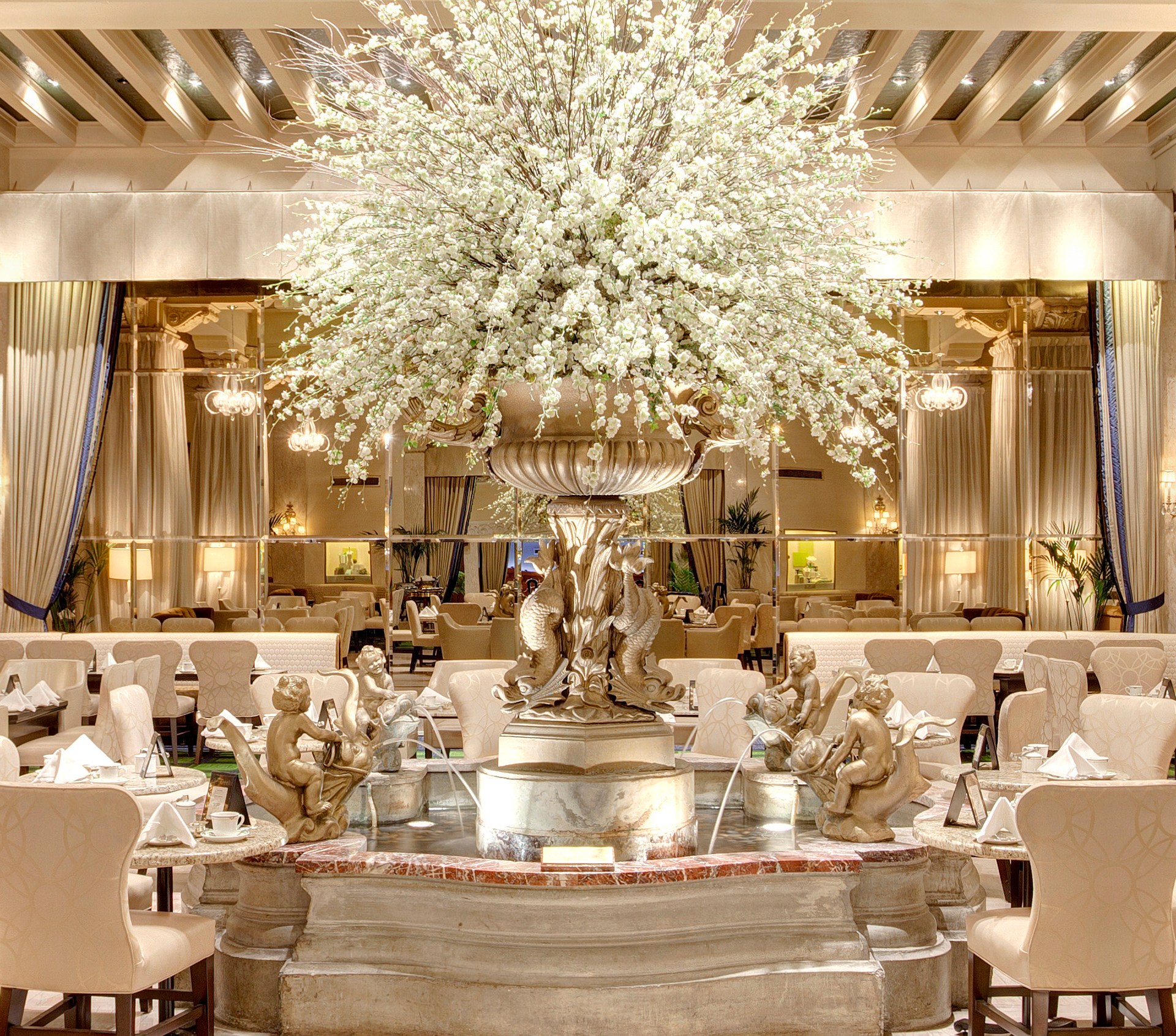 fountain, flower display, dining seating at Palm Court at The Drake Hotel, Chicago