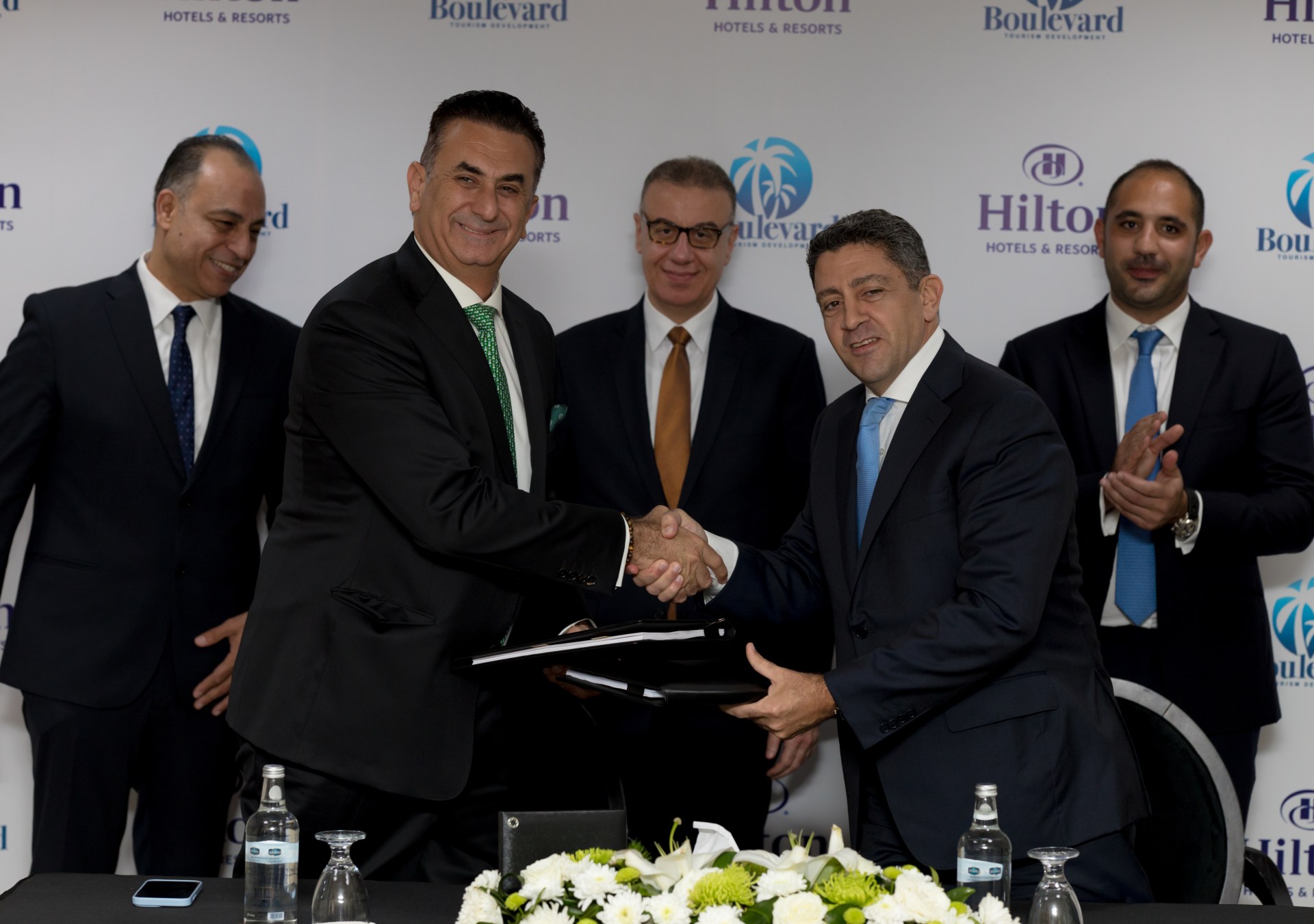 From right to left: Carlos Khneisser, vice president, Development, Middle East & Africa, Hilton shaking hands with Maged Shafik, Founder & Managing Director, Boulevard for Tourism Development.