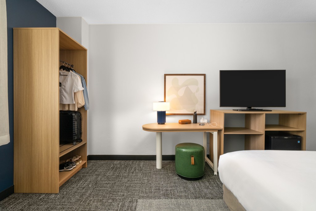 closet and adjustable work station at Spark by Hilton a new hotel brand