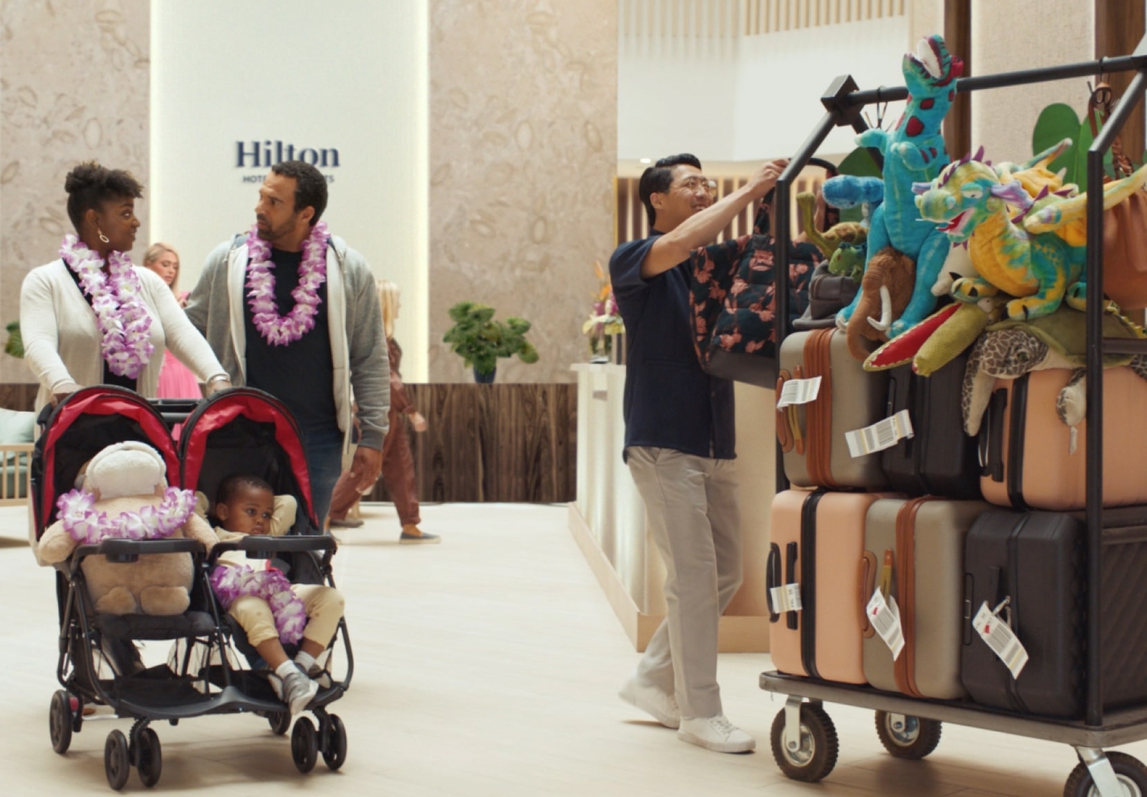 Family checking in to a Hilton Hotel with a stroller.