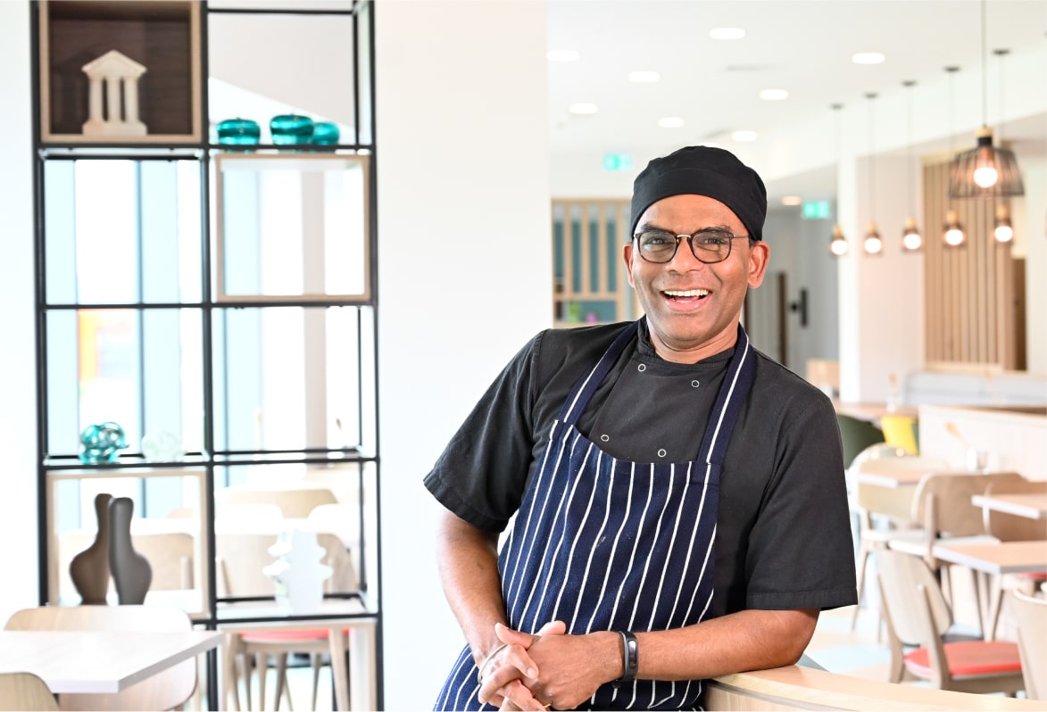 A Hilton restaurant chef smiling.