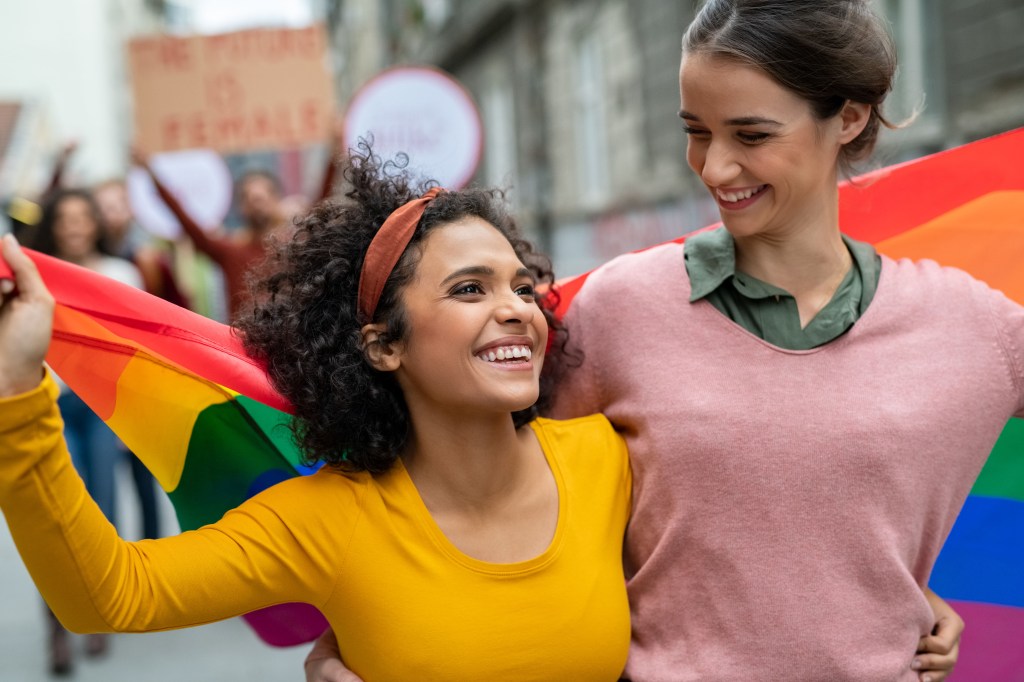 Young women on street with Pride flag