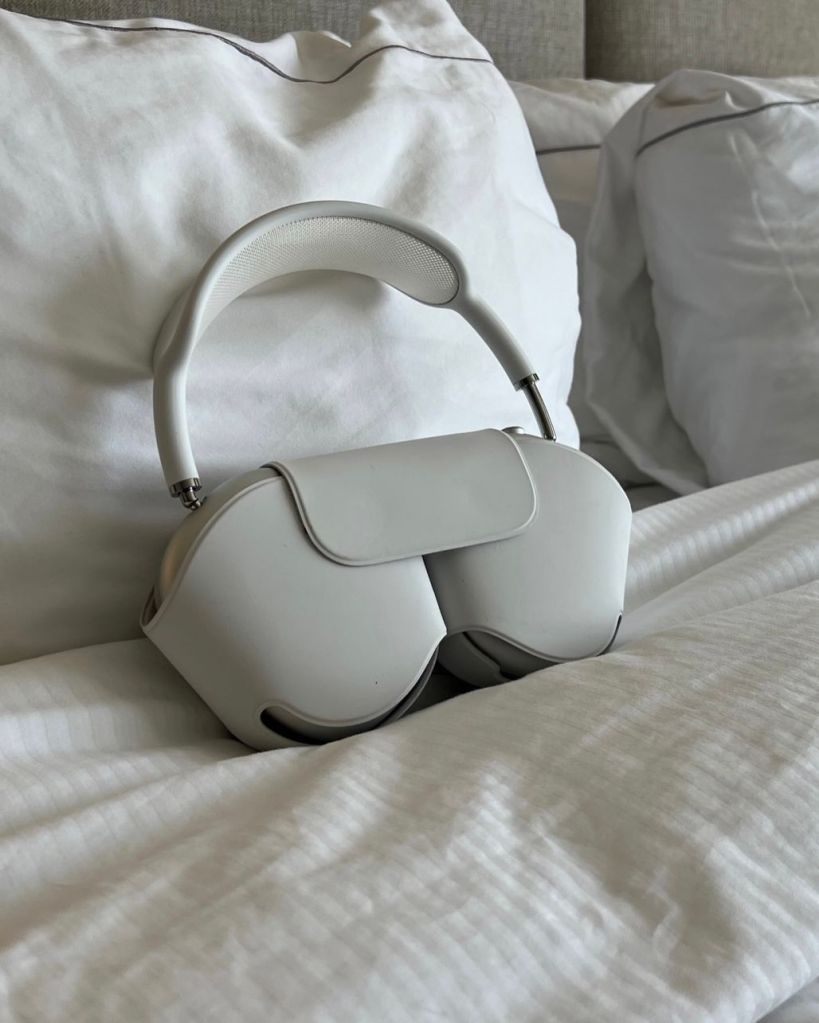 Apple Airpod Max headphones on a bed hotel
