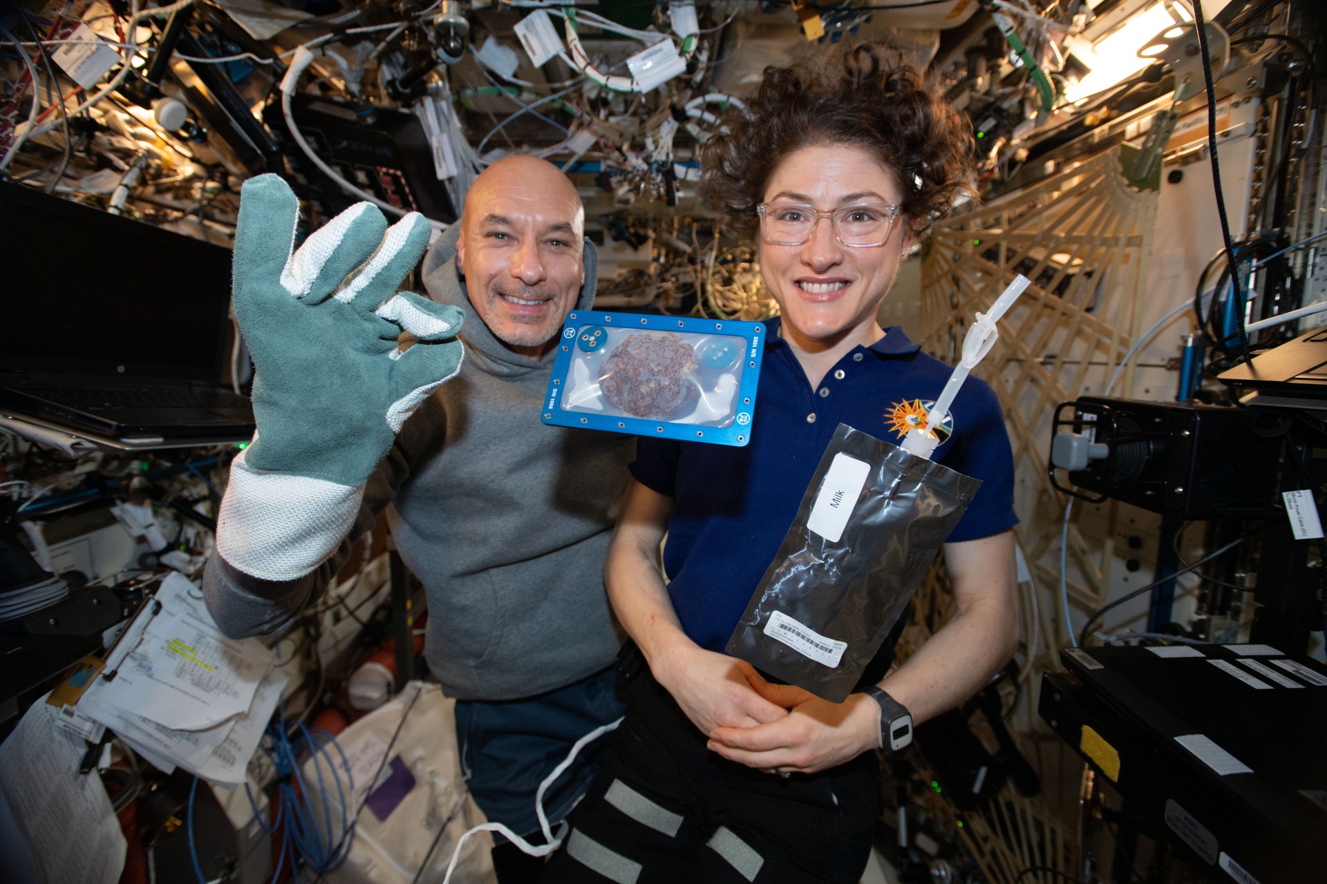 Astronauts Commander Luca Parmitano and Christina Koch with Milk and Cookies - Courtesy: NASA