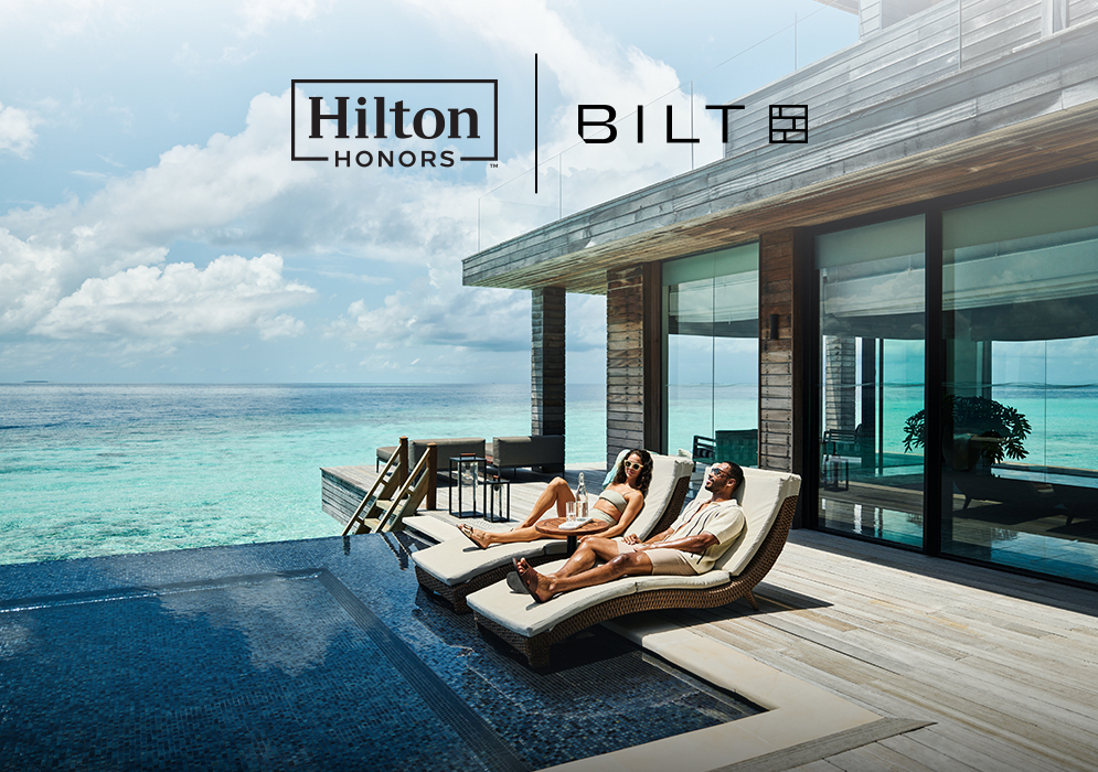 Hilton Honors and Bilt Rewards logos, two people relaxing by the pool