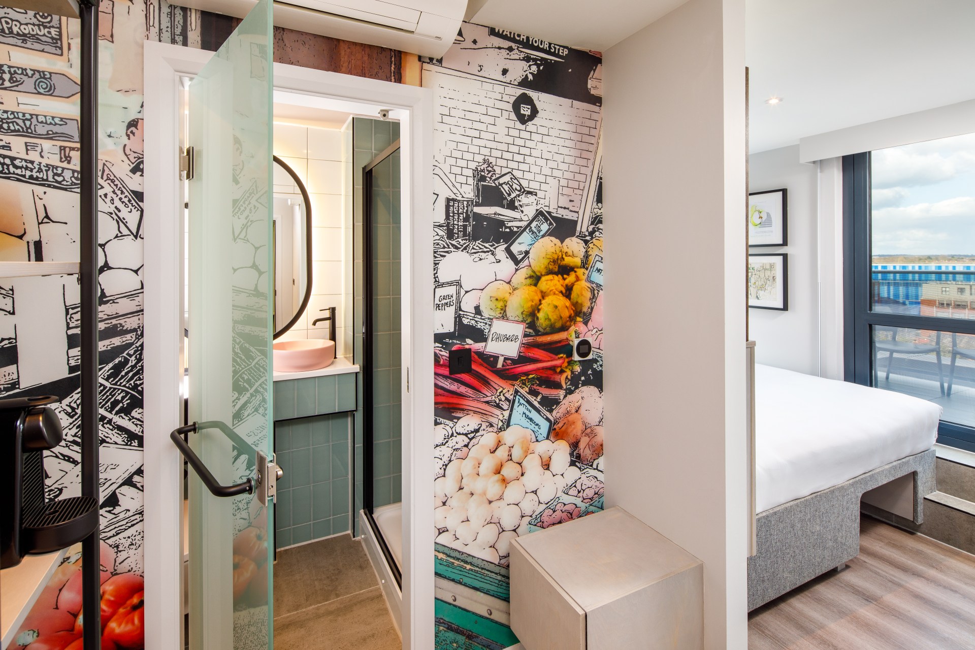 Spark by Hilton London Romford bathroom - colorful wall and door leading into bathroom