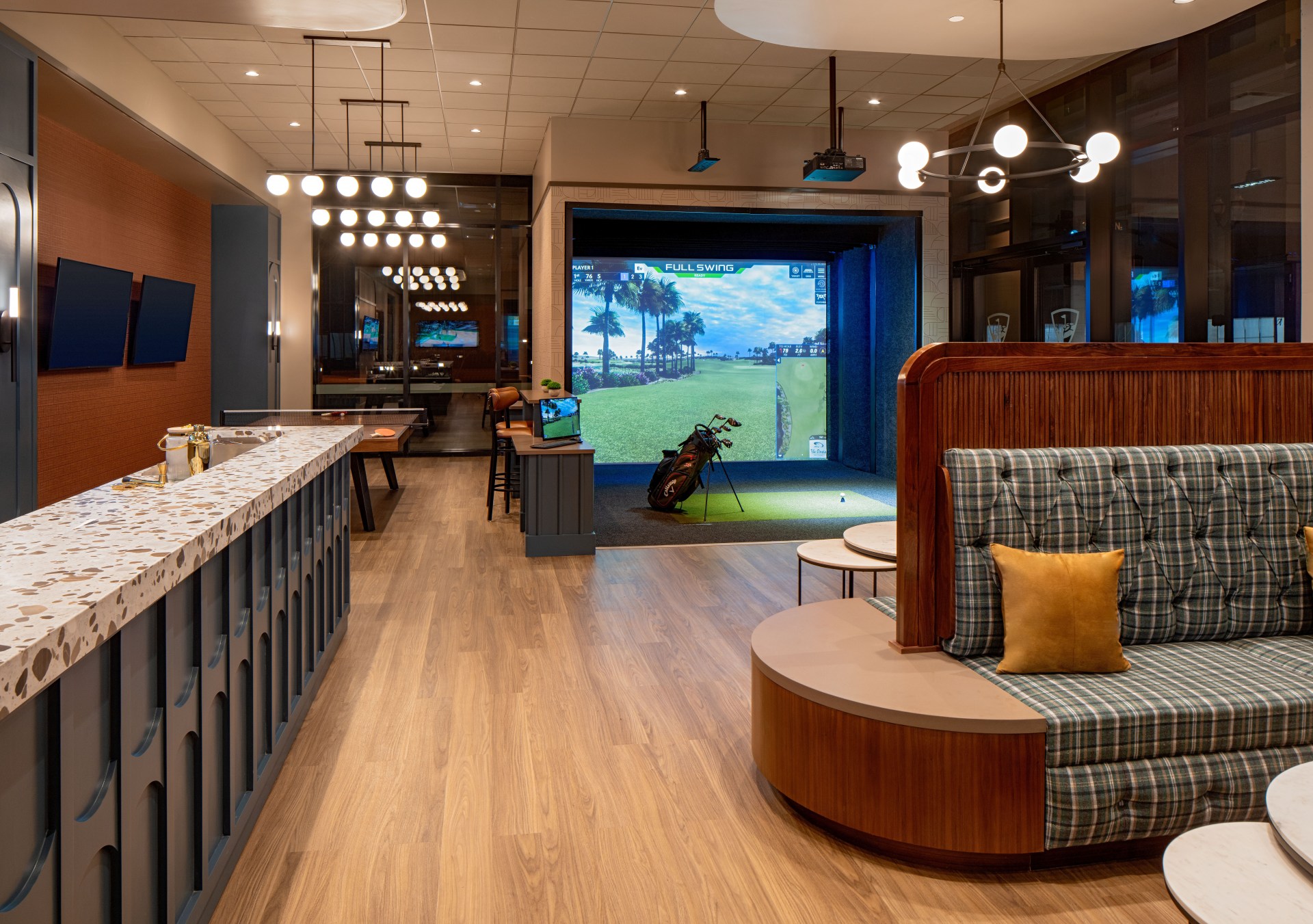 Tempo by Hilton Nashville - Topgolf and Ping Pong - seating and screen with golf clubs