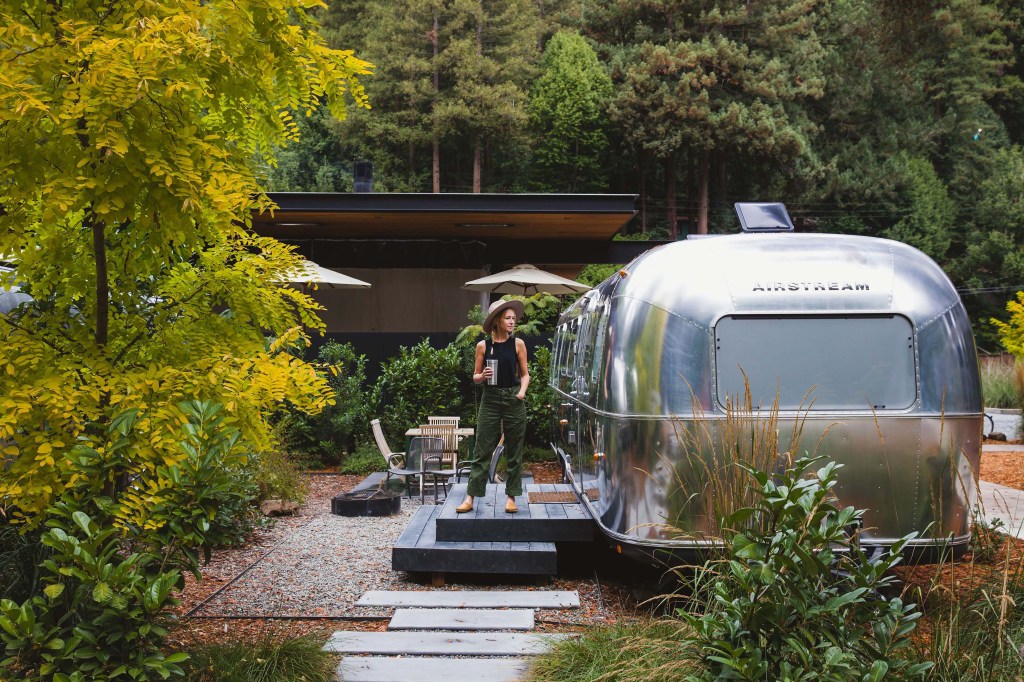woman standing outside of an Airstream at AutoCamp Sonoma