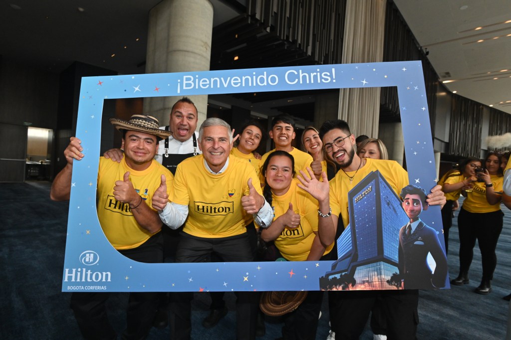 Chris Nassetta and Hilton team members pose with photo frame at Hilton Bogota Corferias