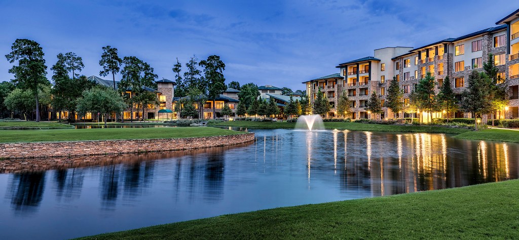 The Woodlands® Resort, Curio Collection by Hilton - Exterior, pond with fountain, trees, at dusk.