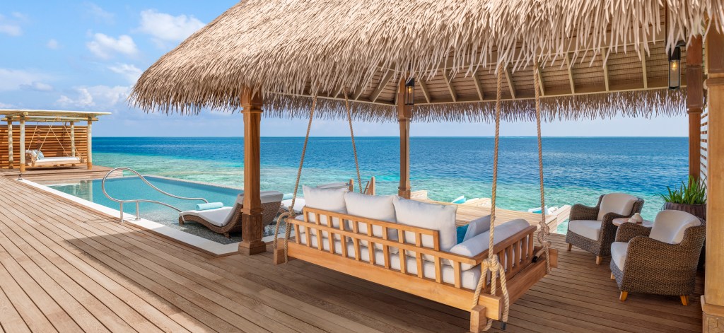 Waldorf Astoria Maldives Ithaafushi - Overwater Villa Pavilion, ocean-facing swing, seating, deck, pool, ocean view