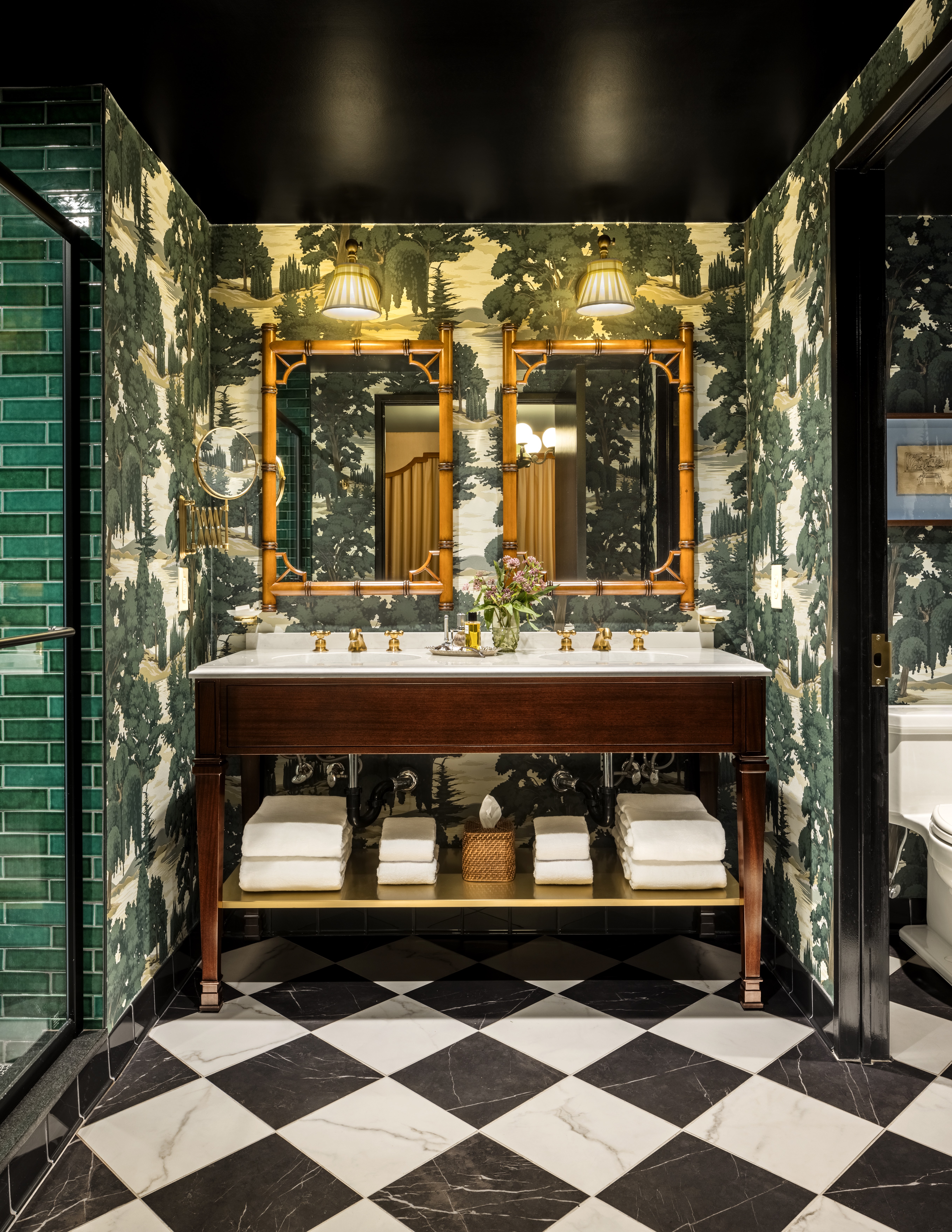 Graduate Princeton Bathroom - double sink with two mirrors and towels underneath sink, separate toilet room off to the right, shower with glass door to left, mirror on wall next to mirrors,
