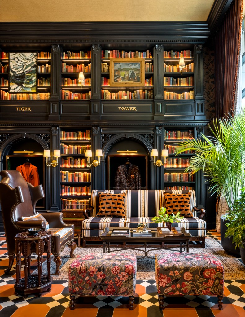 Graduate Princeton Lobby, book shelves, couch, leather arm chair, floral ottoman, arts on walls, plants