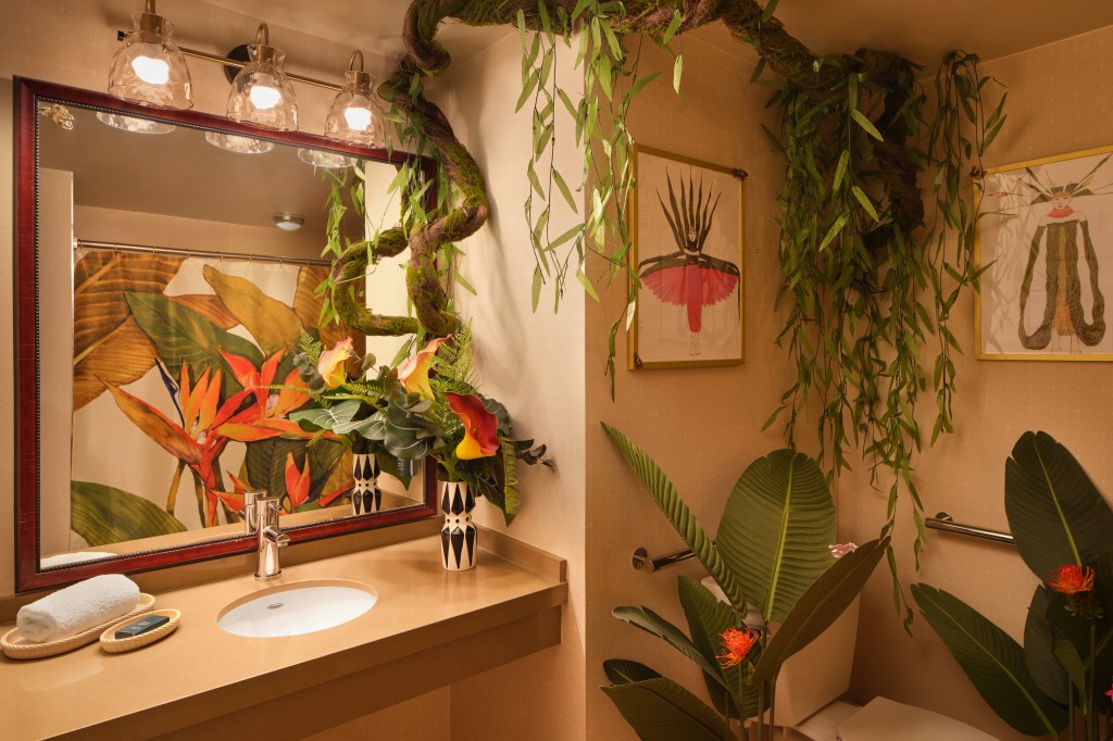 Hilton New York Times Square_THE LION KING's Royal Suite Bathroom, decorative tree branch and plants, concept art on walls