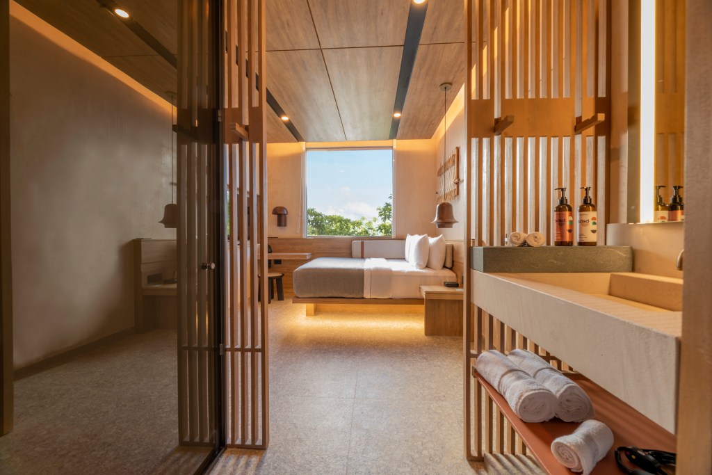 Motto by Hilton Tulum - Guest Room, bed, towels, bathroom sink, wooden slats in walls, seating