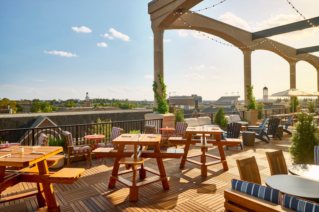 Graduate by Hilton Auburn AL - Rooftop restaurant and bar with a variety of tables and chairs overlooking the Auburn University campus