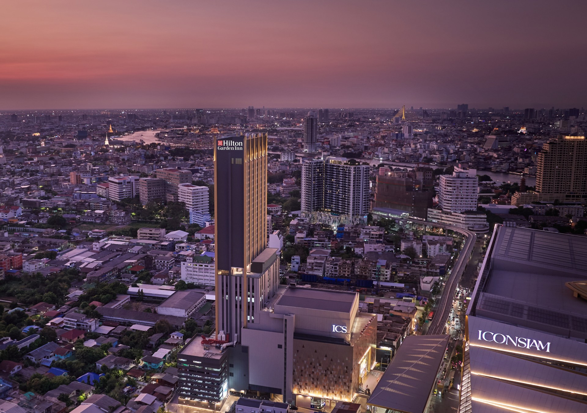 aerial exterior of Hilton Garden Inn Bangkok Riverside with Bangkok skyline