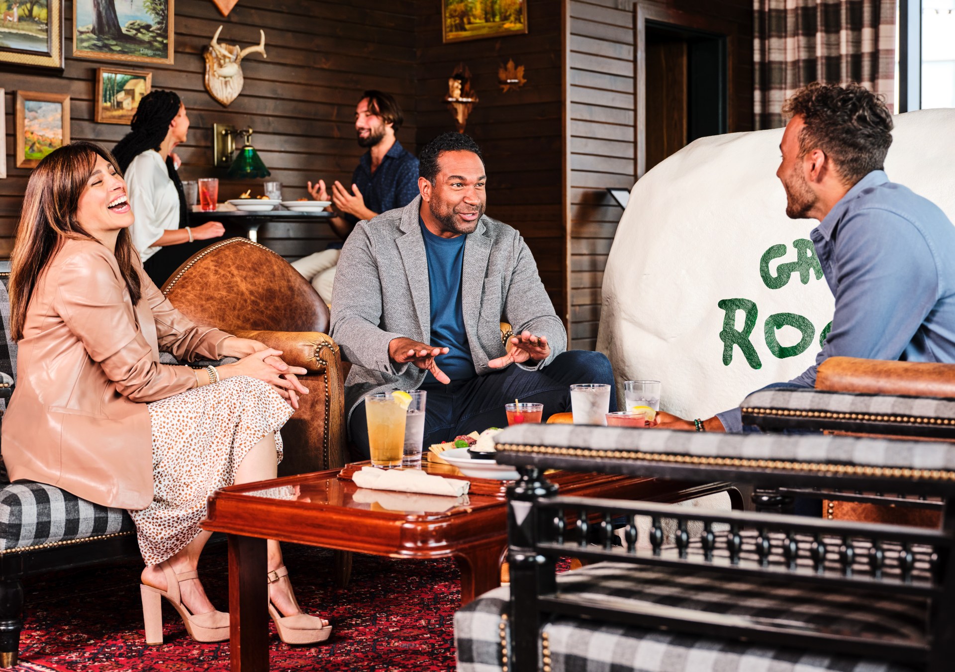 People gathered around a table at Graduate Rock Bar at Graduate by Hilton East Lansing