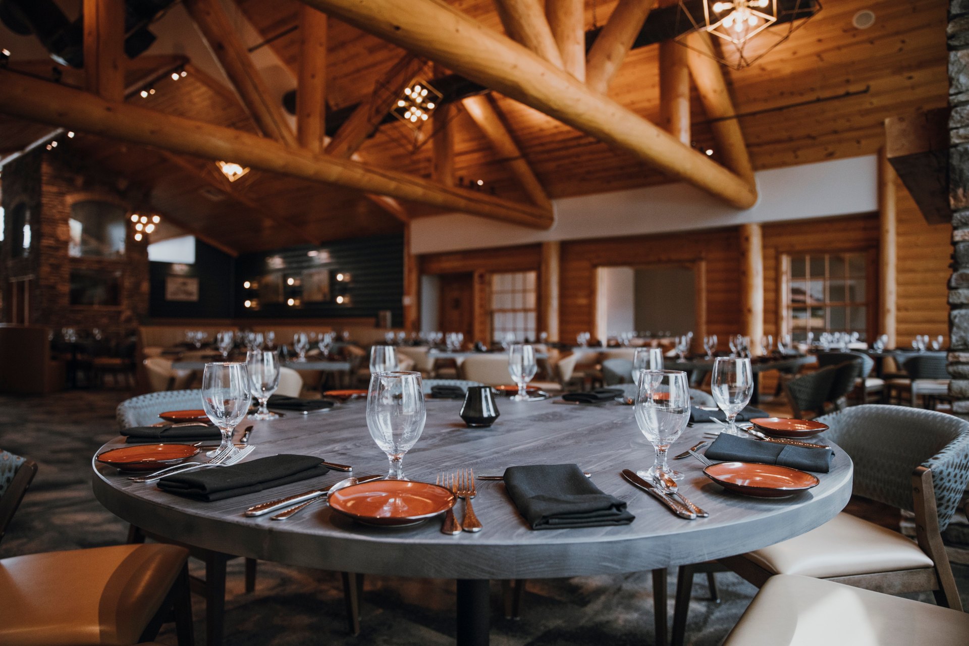 focus on a table in a hotel restaurant, round grey table with place settings all around