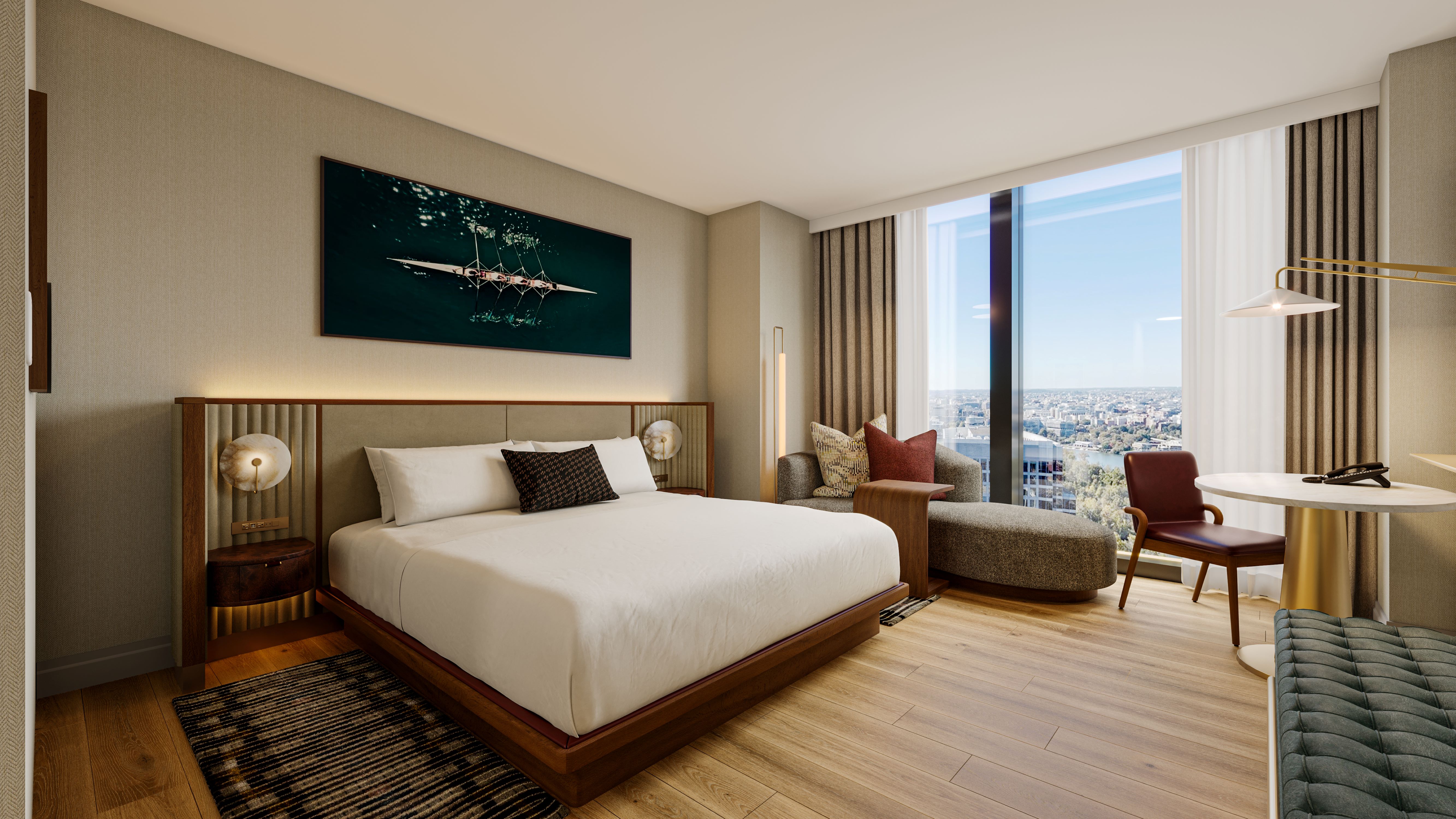 Hilton at the Key Arlington-Rosslyn - Guest Room Rendering - large wooden bed with white bedding and long headboard, artwork above the bed with rowing team, seating in front of floor-to-ceiling window overlooking the city