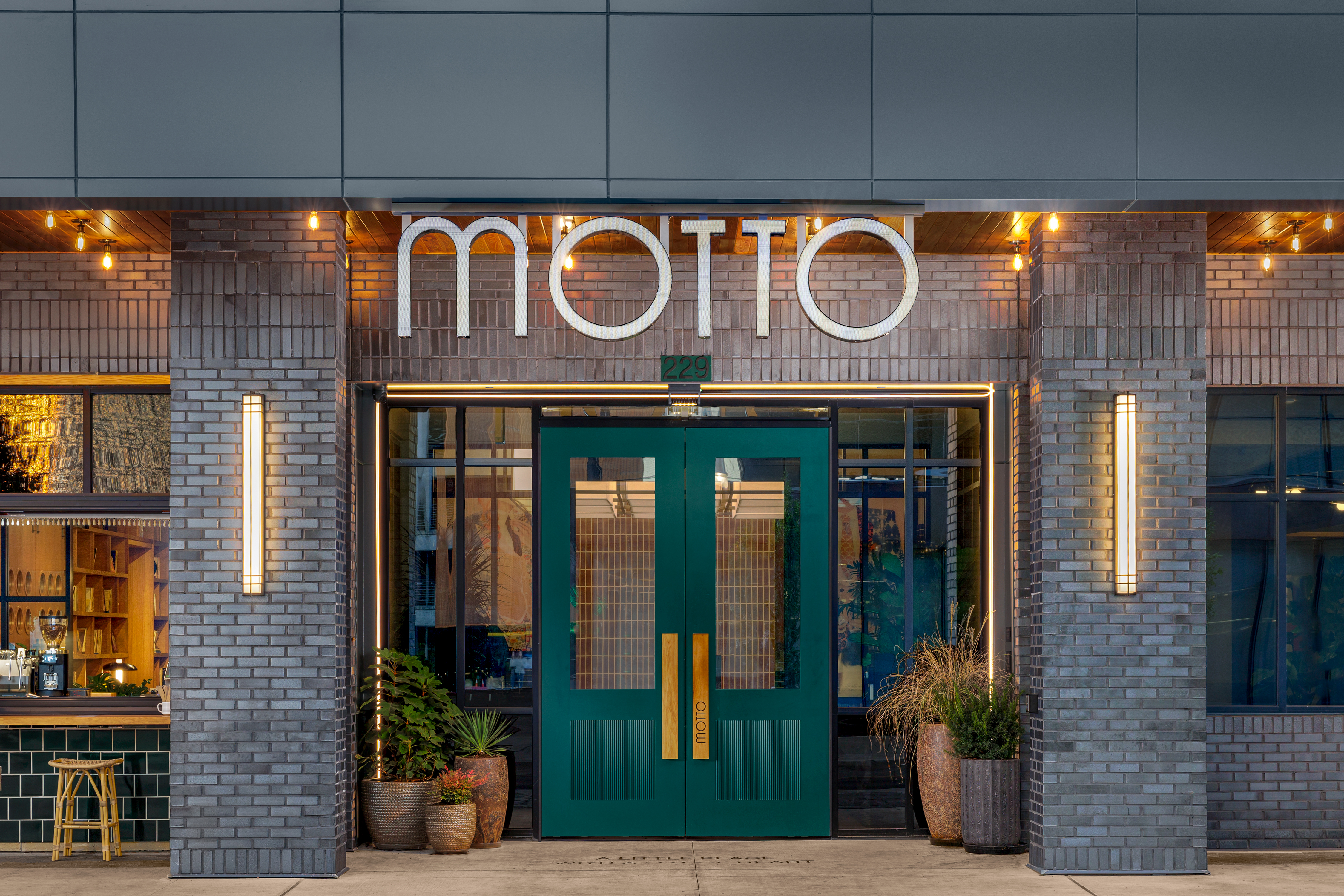 Motto by Hilton Bentonville Downtown, Entrance, green door, wooden door handle, bar stool, planter pot