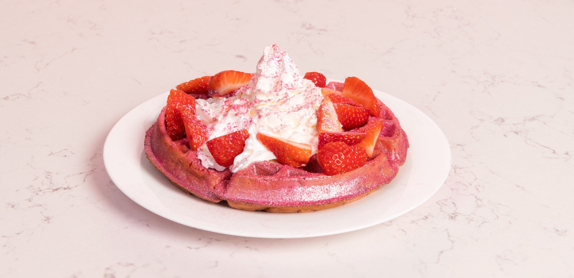 Sparkling Strawberry Hampton Waffle by Paris Hilton - pink waffle topped with strawberries, whipped cream and edible glitter